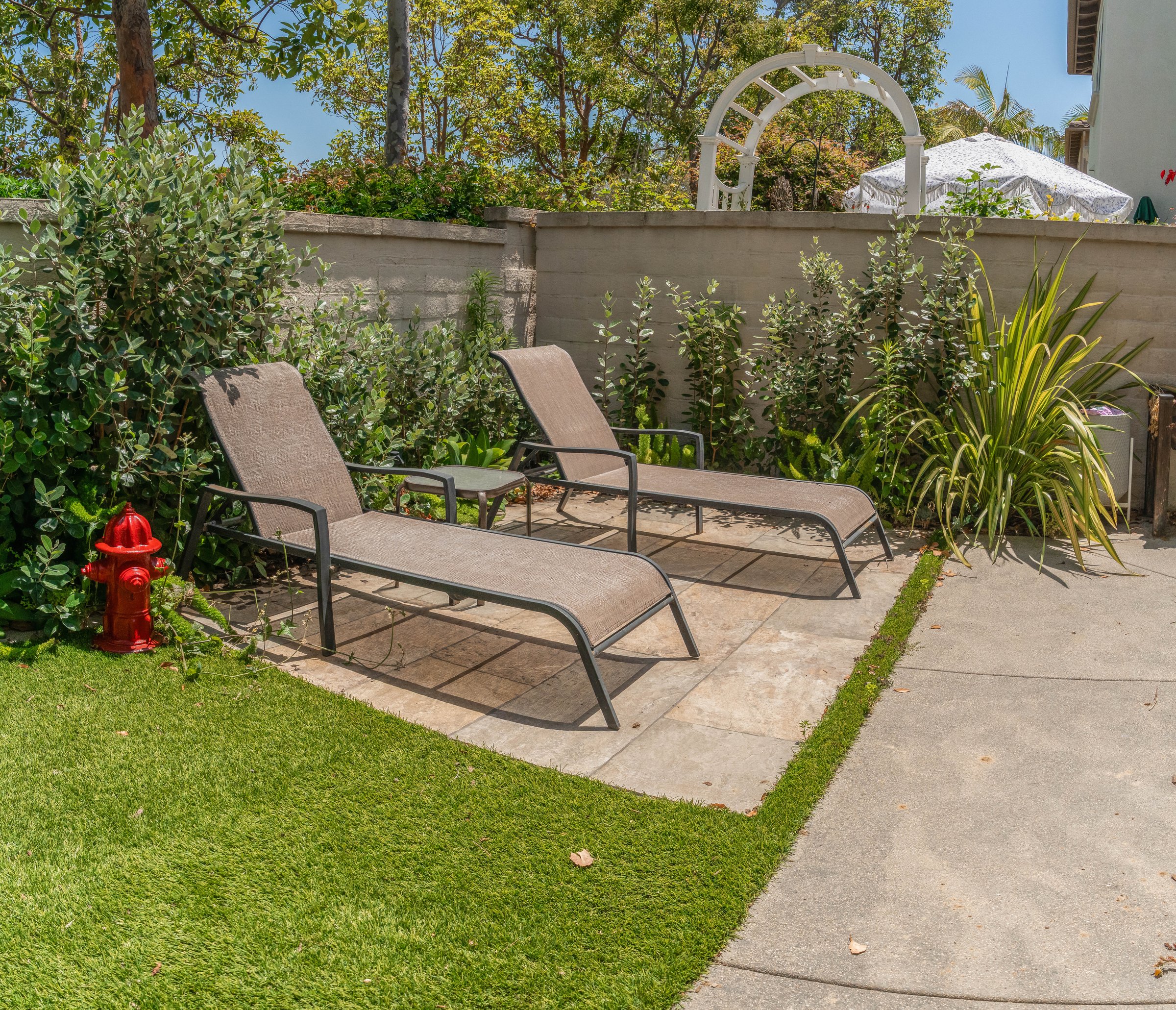 Outdoor patio with loungers and garden